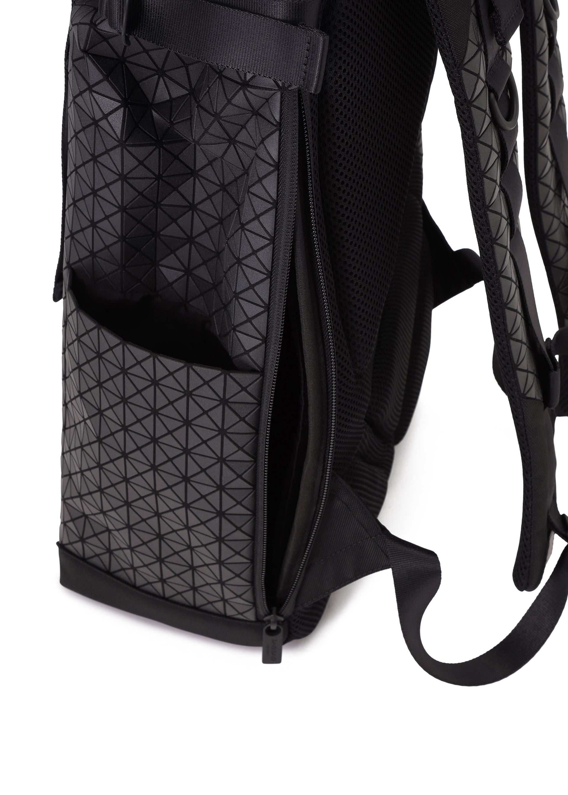 Zoomed view A close-up of the BAO BAO ISSEY MIYAKE HIKER backpack shows its geometric triangle pattern, side pocket, and a partially opened zipper revealing the inner compartment with a laptop pocket.