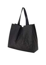 The BAO BAO ISSEY MIYAKE CART tote bag showcases an all-over geometric triangular pattern with two adjustable handles and is displayed against a white background.