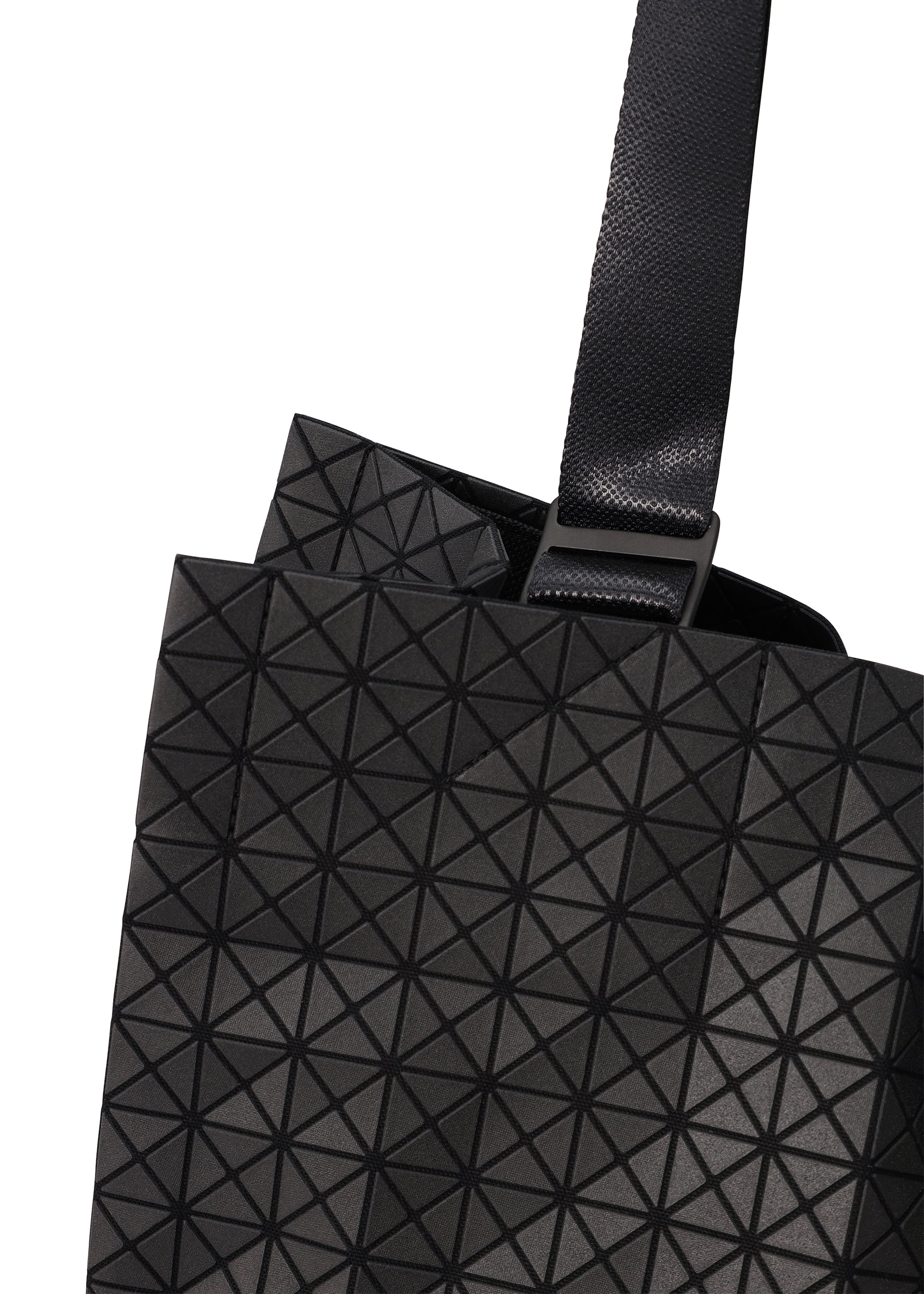 Zoomed view Close-up of a CART tote bag by BAO BAO ISSEY MIYAKE, featuring a black geometric-patterned design with adjustable handles and a wide textured strap. Raised triangles form a striking grid, making it ideal as an A4 laptop bag.