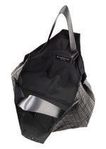 A geometric-patterned black BAO BAO ISSEY MIYAKE CART tote bag with an open top, two handles, fabric lining, interior label, and a spacious interior—ideal for carrying an A4 laptop.