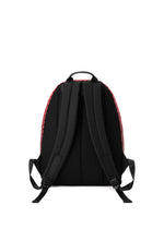 The black DAYPACK GRADUAL backpack by BAO BAO ISSEY MIYAKE is shown from the back, featuring two padded shoulder straps, a top handle, and sides trimmed in red with a subtle geometric pattern that enhances its three-dimensional shape. The background is plain white.