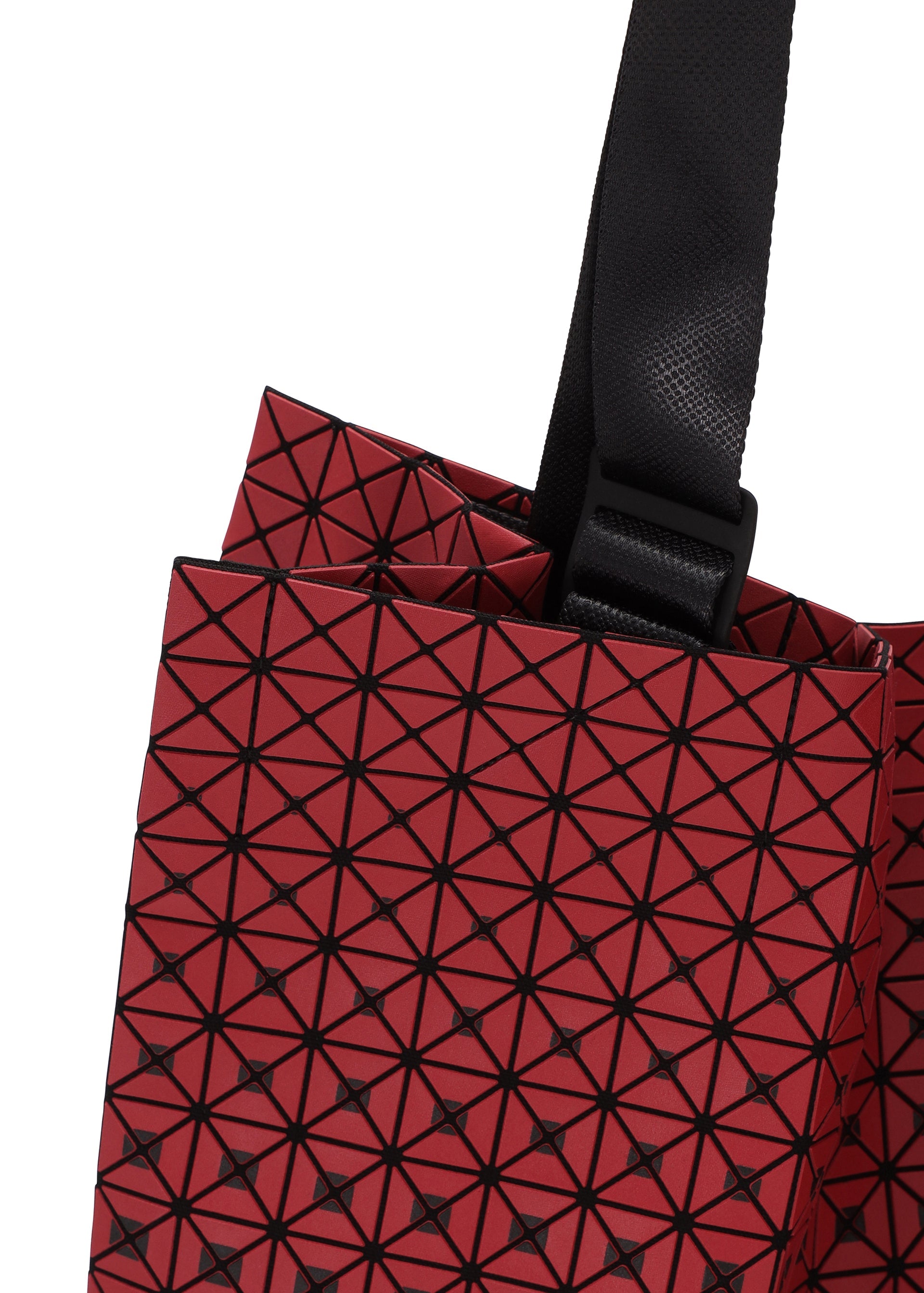 Zoomed view Close-up of the CART GRADUAL tote bag by BAO BAO ISSEY MIYAKE, showcasing its striking red geometric pattern with black lines forming triangles and an adjustable black strap attached at the top—perfect for carrying A4-sized documents.