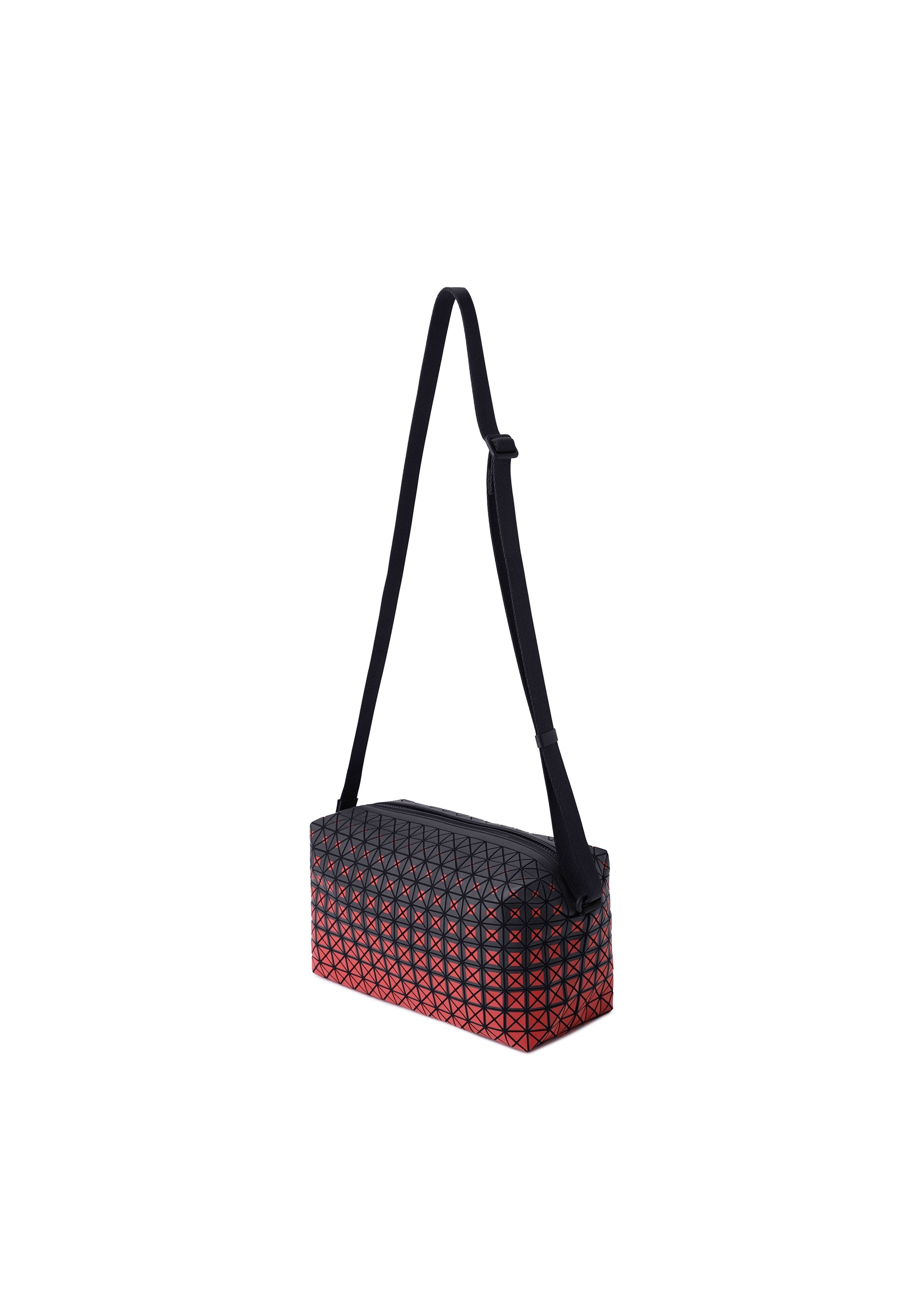 Zoomed view SADDLE BAG GRADUAL by BAO BAO ISSEY MIYAKE is a rectangular crossbody bag from the KURO series, showcasing a bold geometric black grid pattern over a striking red graphic gradation background with a long adjustable black strap. This box-shaped shoulder bag is photographed on a plain white background.