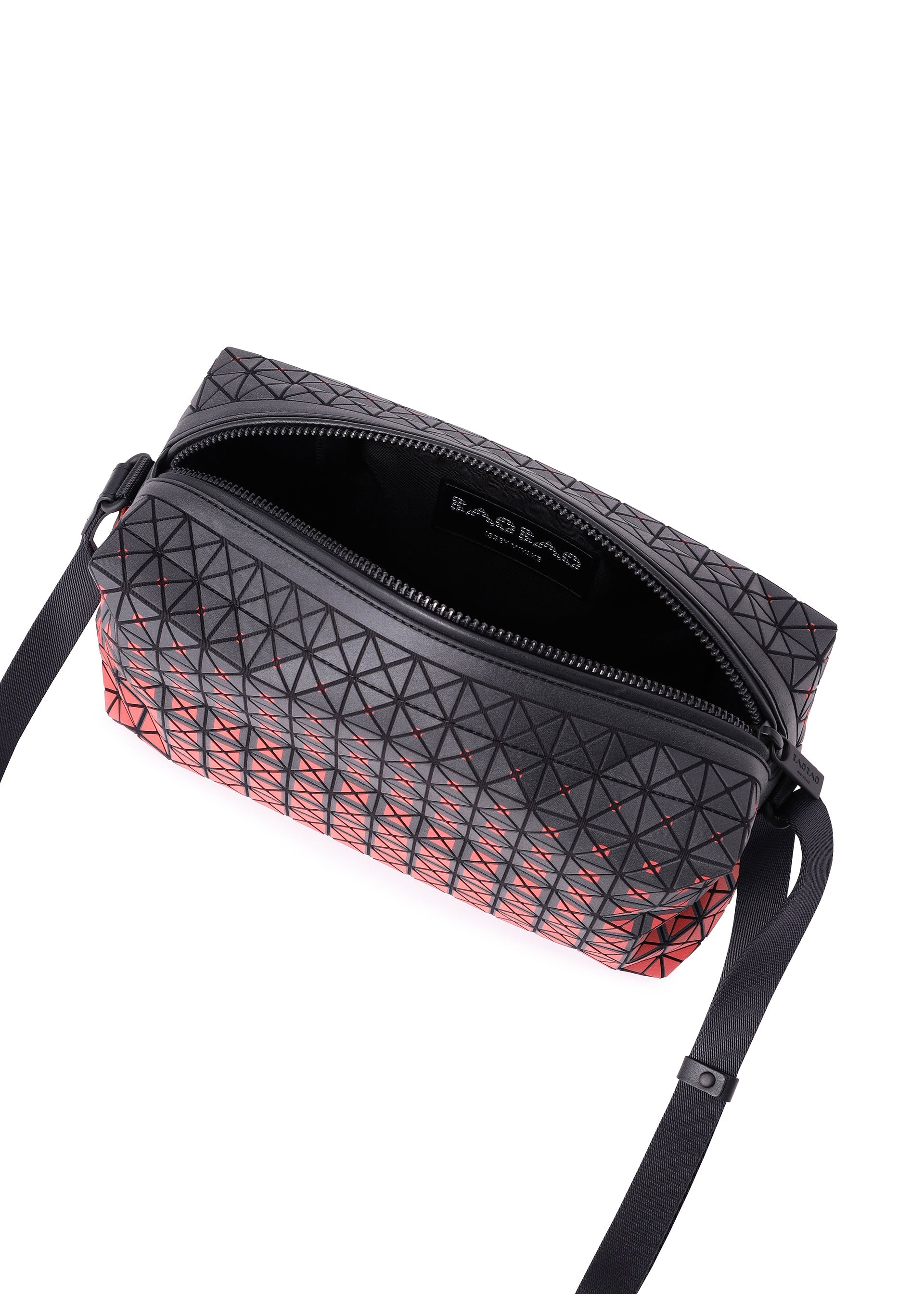 Zoomed view Certainly! Here’s a rewritten sentence using the provided product data: The SADDLE BAG GRADUAL from BAO BAO ISSEY MIYAKE is a black, box-shaped shoulder bag featuring a striking geometric triangle pattern with red accents. Displayed open with its interior label visible and an adjustable black strap, the bag’s graphic gradation design is beautifully highlighted when viewed from above against a white background.