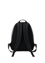 The BAO BAO ISSEY MIYAKE DAYPACK REFLECTOR is a black 3D backpack with two padded shoulder straps, a top handle, adjustable strap ends, and subtle geometric patterns on the sides. Shown from the back against a plain white background.