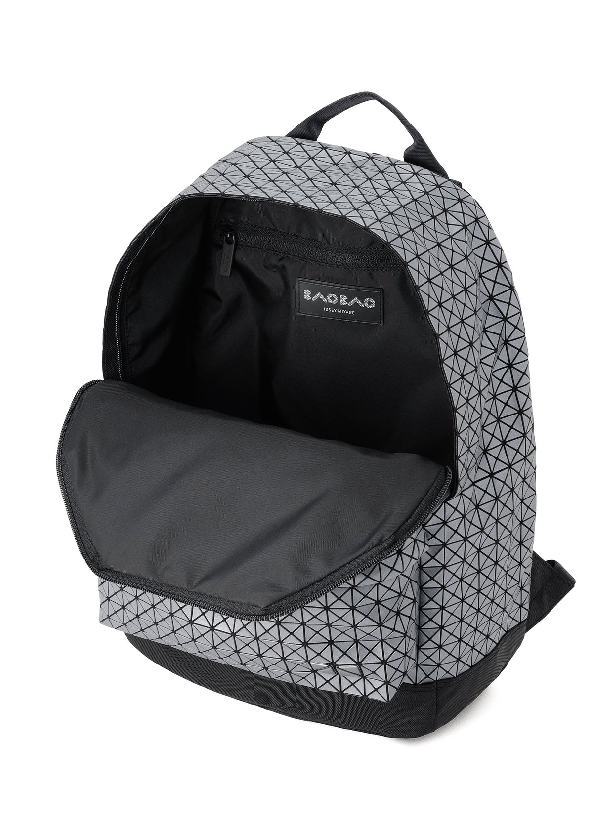 The BAO BAO ISSEY MIYAKE DAYPACK REFLECTOR is a gray backpack with a black geometric pattern, shown open to reveal its spacious main compartment, black interior and zipper, and a visible BAO BAO label inside. view 4 of 7