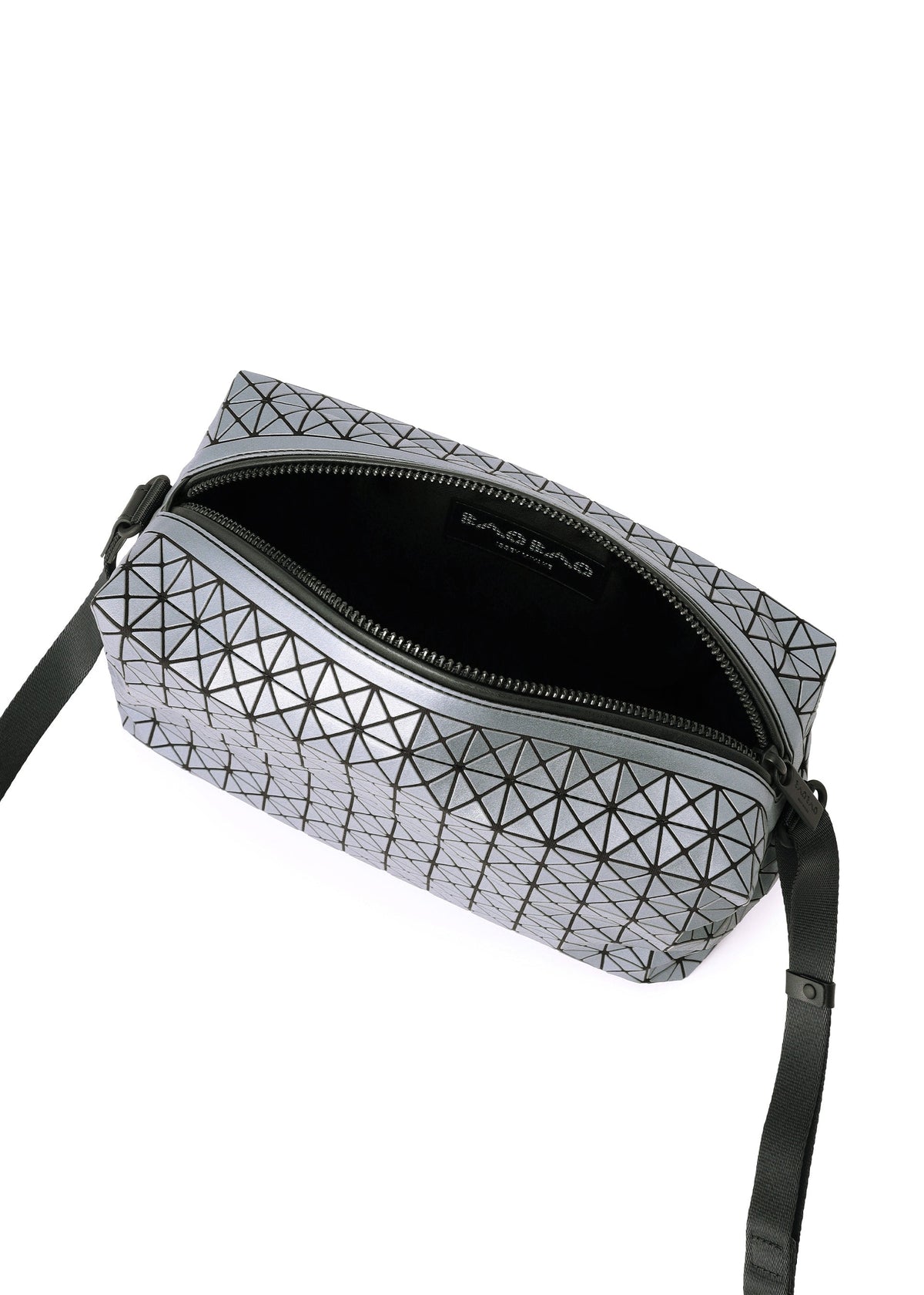 The BAO BAO ISSEY MIYAKE SADDLE BAG REFLECTOR is a small rectangular bag with a geometric triangular pattern, black adjustable crossbody strap, zip closure, partially open to show its black interior and branded label. view 5 of 8
