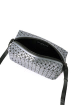 The BAO BAO ISSEY MIYAKE SADDLE BAG REFLECTOR is a small rectangular bag with a geometric triangular pattern, black adjustable crossbody strap, zip closure, partially open to show its black interior and branded label.