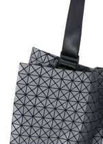 Close-up of the CART REFLECTOR tote by BAO BAO ISSEY MIYAKE, featuring metallic gray triangular patterns and adjustable black handles for versatile carrying.