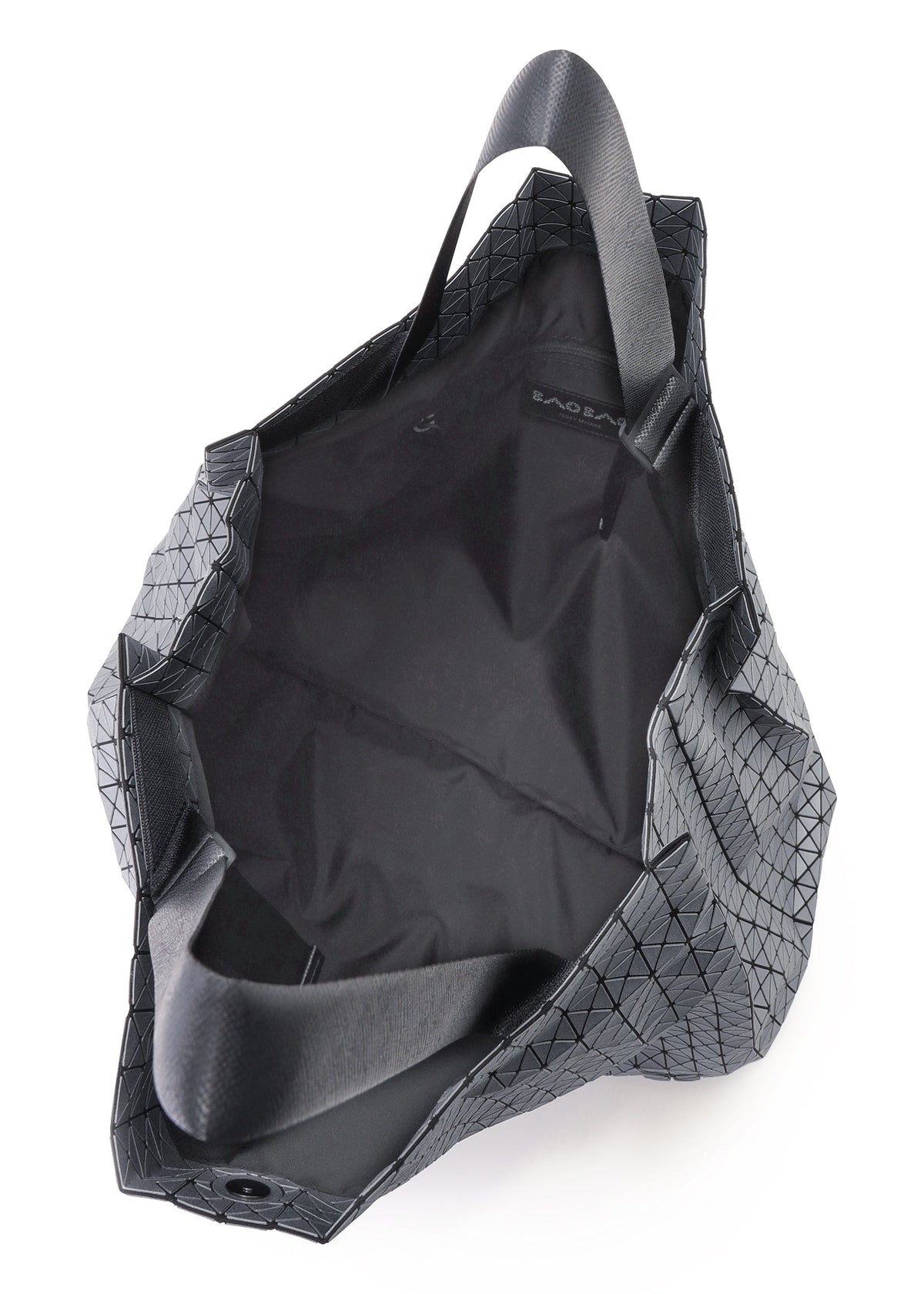 The CART REFLECTOR by BAO BAO ISSEY MIYAKE is a black tote bag with a geometric pattern and adjustable handles, shown from above to display its spacious, unlined interior and a small inner label. view 5 of 8