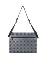 The FROGGY REFLECTOR by BAO BAO ISSEY MIYAKE is a grey, rectangular messenger bag with a geometric pattern, large storage capacity, black adjustable shoulder strap, and front zippered pocket, shown on a white background.