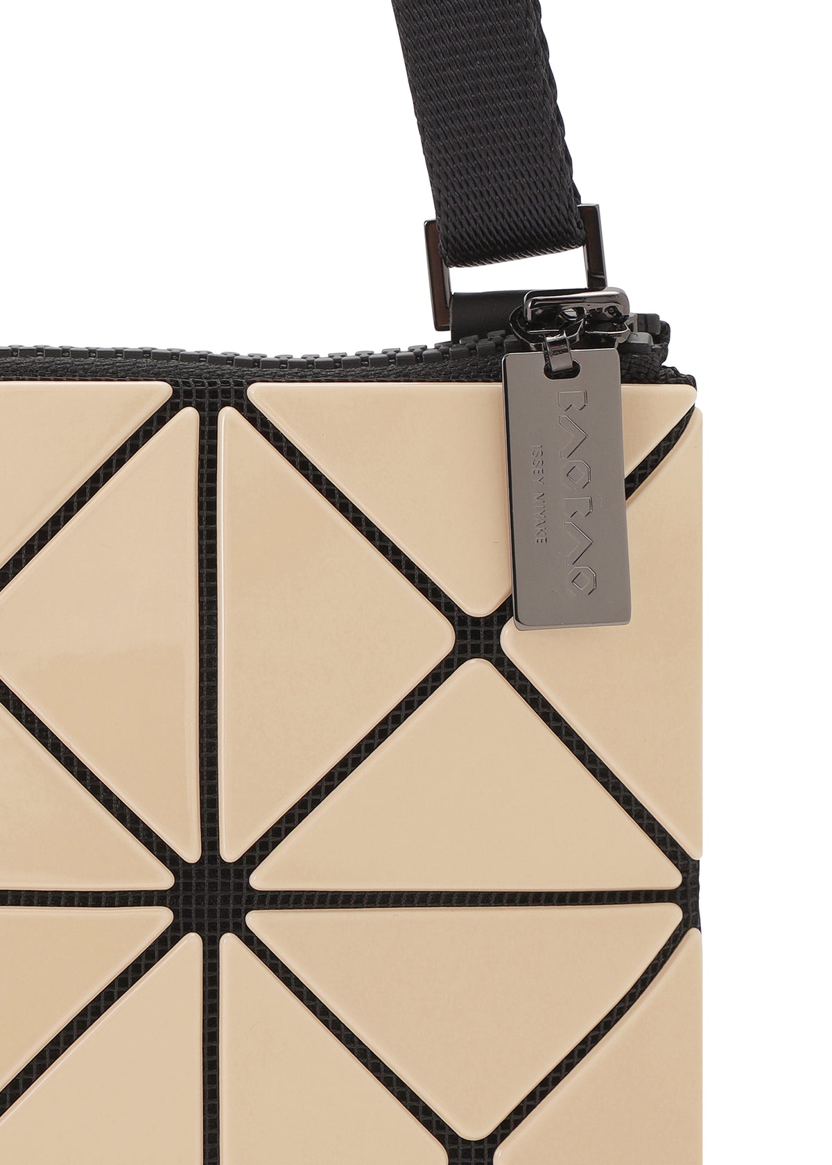 Zoomed view A beige BAO BAO ISSEY MIYAKE LUCENT GLOSS shoulder bag made of geometric triangular panels with a black strap and a rectangular metal zipper pull.