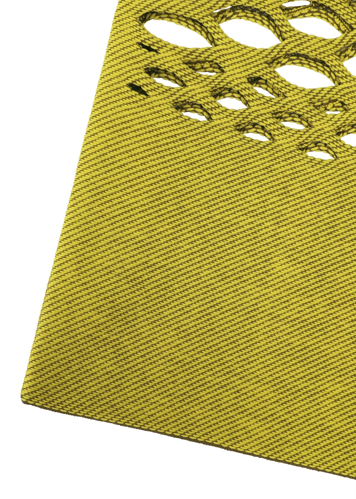 A close-up of the MOKKO BASKET by GOOD GOODS ISSEY MIYAKE shows its yellow textured surface with diagonal lines and oval cutouts in the upper right corner. view 4 of 8