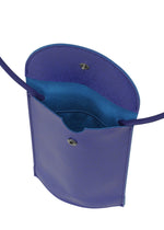 The PACKAGE by GOOD GOODS ISSEY MIYAKE is a small, open purple pochette crossbody bag with a snap closure and visible interior pocket—ideal for carrying sweets or as a charming gift, shown from above.