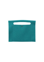 The KURURI by GOOD GOODS ISSEY MIYAKE is a flat, rectangular teal fabric bag featuring a top handle and front button closure, designed with a simple and minimalist aesthetic. - EMERALD （no.61）