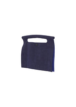 The KURURI by GOOD GOODS ISSEY MIYAKE is a navy blue suede clutch with a cut-out top handle and small front button closure, displayed against a white background.