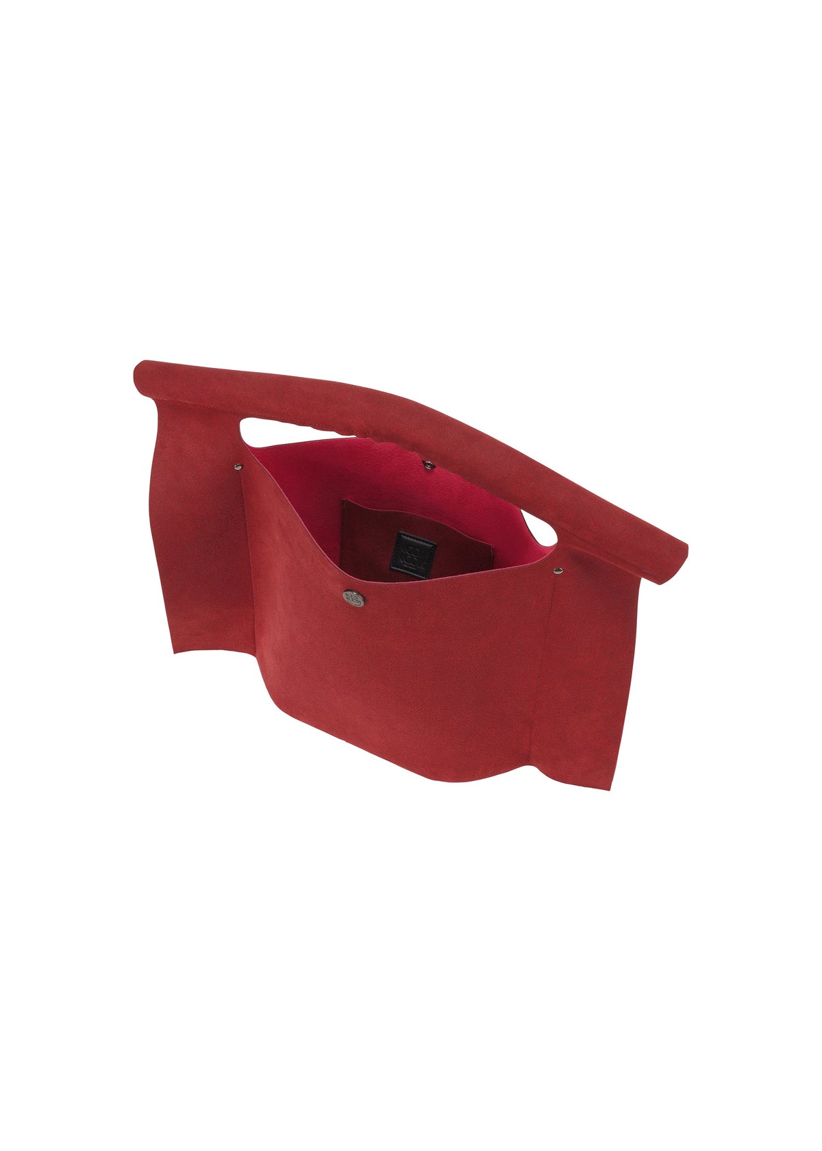 The KURURI by GOOD GOODS ISSEY MIYAKE is a red suede clutch, shown open from above to reveal a roomy inner compartment with a black label. It features a snap button closure and an integrated handle in the top flap. view 9 of 15