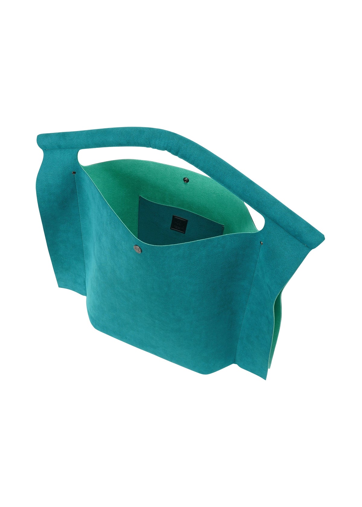 The KURURI bag by GOOD GOODS ISSEY MIYAKE is teal with an angular handle, open top, snap button closure, spacious interior, and a small inner pocket. Shown against a white background. view 9 of 17