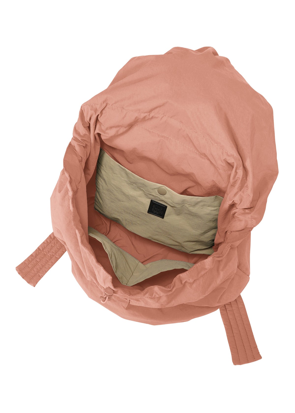 Open view of the FUWA FUWA backpack by GOOD GOODS ISSEY MIYAKE, featuring a spacious zero-waste interior, a light beige buttoned inner pocket, and two pink padded shoulder straps in a sustainable design. view 4 of 6
