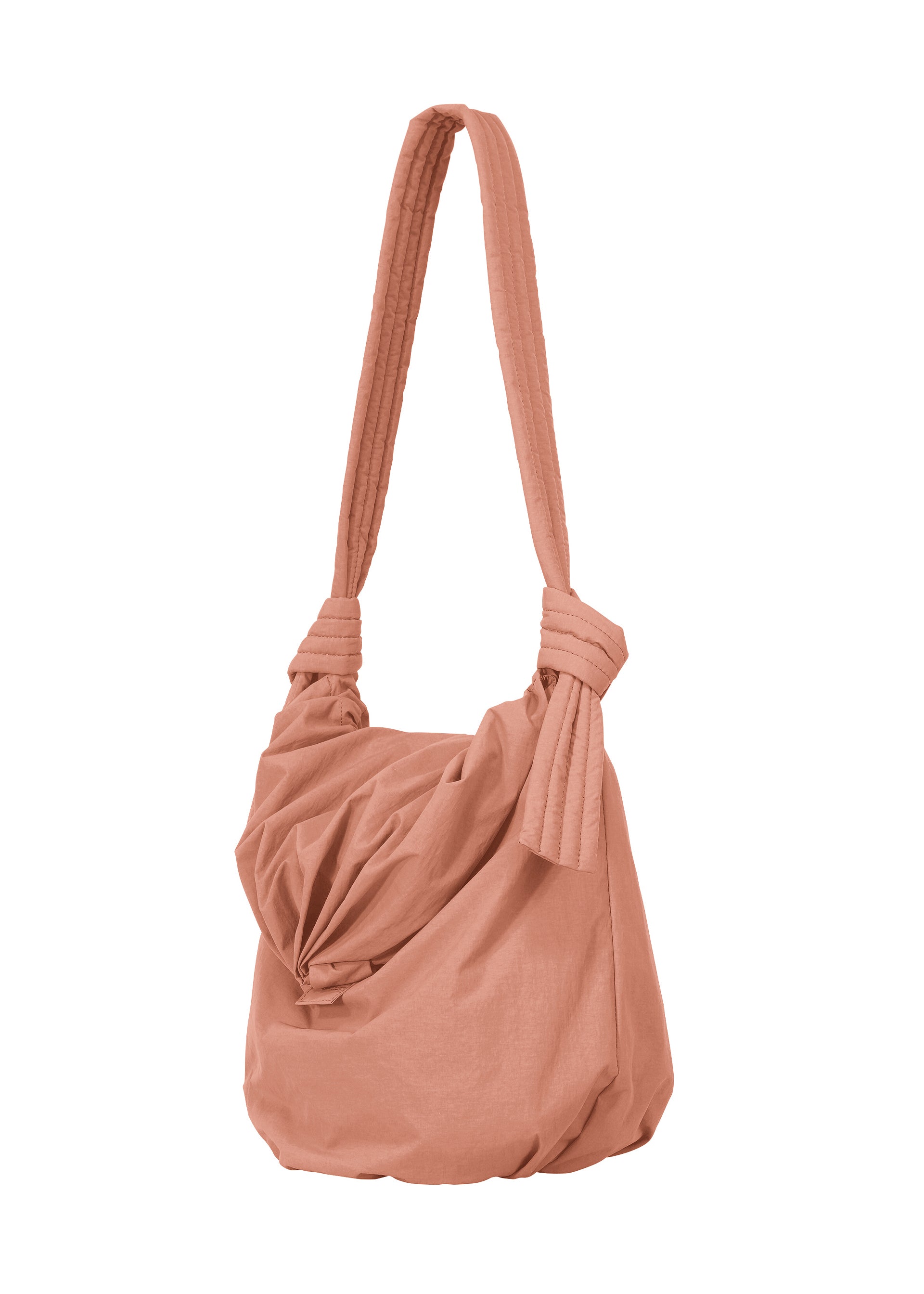 Zoomed view The FUWA FUWA by GOOD GOODS ISSEY MIYAKE is a peach fabric shoulder bag with a knotted strap and gathered, draped front inspired by Japanese aesthetics, shown on a white background.