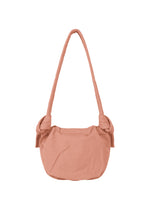 The FUWA FUWA by GOOD GOODS ISSEY MIYAKE is a soft, light pink rounded shoulder bag with a long strap and gathered details, crafted using zero-waste design inspired by Japanese noragi techniques.
