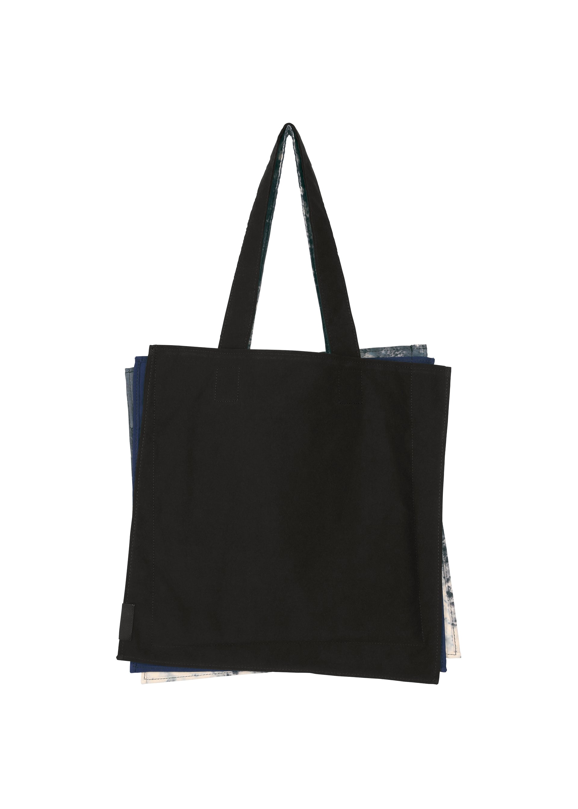 Zoomed view A black IROGAMI SALT DYE tote bag by GOOD GOODS ISSEY MIYAKE, featuring long handles and layered over colorful sections peeking from the sides, displayed against a white background.