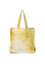The IROGAMI SALT DYE tote bag by GOOD GOODS ISSEY MIYAKE features a yellow and light blue Shio-zome pattern, two handles, and a small black side tag, shown against a white background. - YELLOW MIX （no.55）
