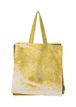 The IROGAMI SALT DYE tote bag by GOOD GOODS ISSEY MIYAKE features long handles and a soft, lightweight fabric with a yellow and green marbled pattern created by salt-dyeing on a white background. - YELLOW MIX （no.55）