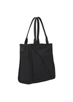 The WAKU by GOOD GOODS ISSEY MIYAKE is a black fabric tote bag with two long handles, wide gussets for extra space, and an exterior diagonal pocket, shown on a white background.