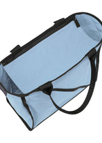 The WAKU tote bag by GOOD GOODS ISSEY MIYAKE is light blue with black handles and a zipper. Seen from above with the zipper open, its roomy interior and wide gussets offer extra space.