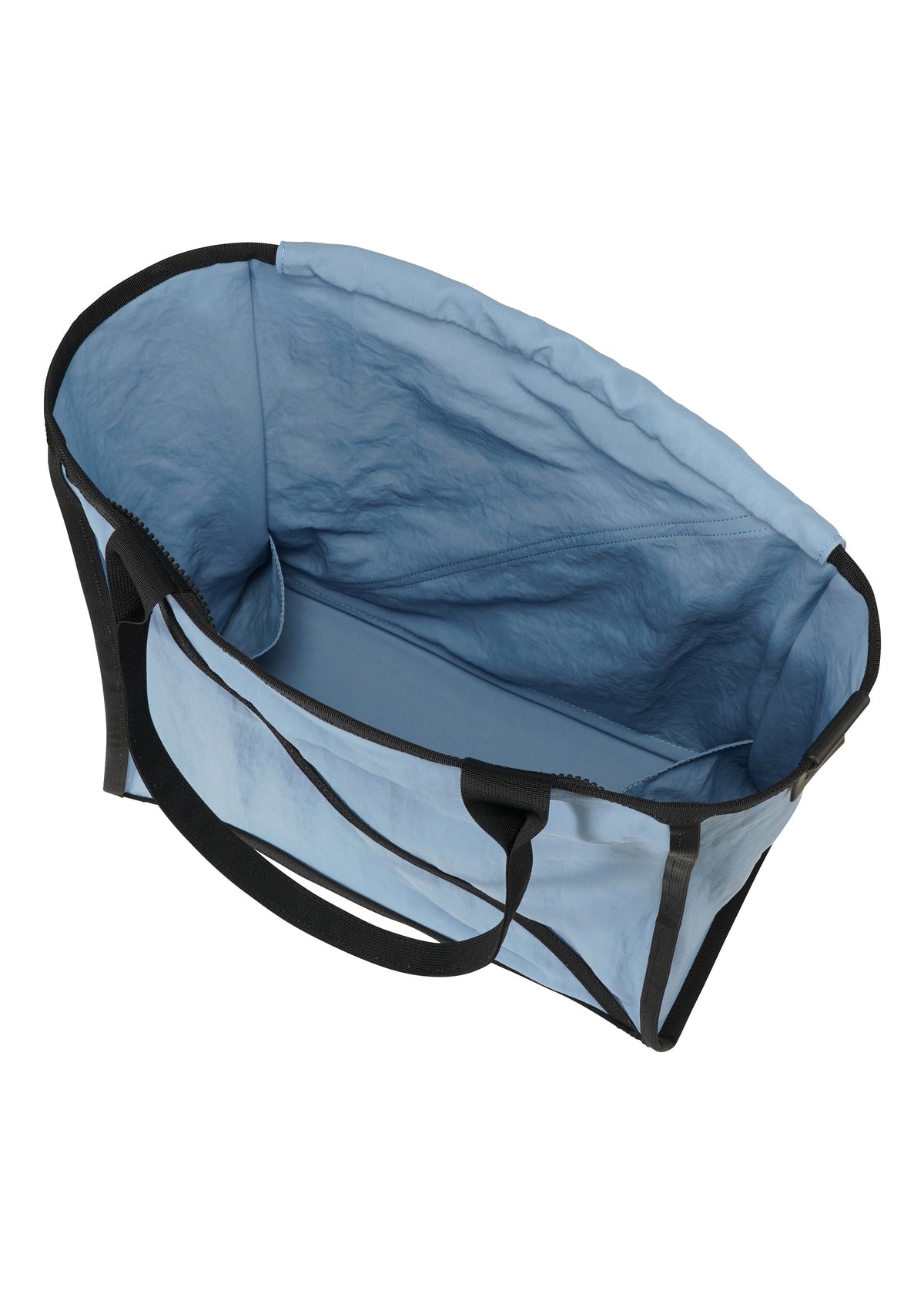 The WAKU tote bag by GOOD GOODS ISSEY MIYAKE is a large, light blue fabric bag with black handles and trim, wide gussets for extra space, shown from above on a white background. view 4 of 6