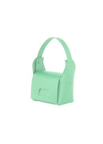 The BOX bag by GOOD GOODS ISSEY MIYAKE is a small mint green shoulder handbag with a wide handle, minimalist design, silver rivets, and a flap closure. It is displayed against a plain white background.