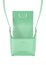 The BOX by GOOD GOODS ISSEY MIYAKE is a mint green leather handbag with a structured, box-inspired shape, open top flap, front embossed logo, and minimalist modern design.