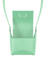 The BOX bag by GOOD GOODS ISSEY MIYAKE is a minimalist mint green, box-inspired design with a structured shape, open front flap, and thin strap, shown against a white background.