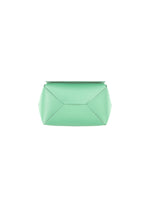 The BOX clutch by GOOD GOODS ISSEY MIYAKE is a mint green, geometric bag with sharp, folded edges, showcased against a plain white background.