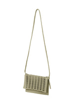 A close-up of the MOKKO FLAP POUCH by GOOD GOODS ISSEY MIYAKE, highlighting its textured knit design and versatile, stylish look.