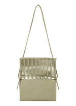 The MOKKO FLAP POUCH by GOOD GOODS ISSEY MIYAKE is a beige knit shoulder bag with a long strap, an open-top woven section over a solid rectangular base, and side ties for style and practicality. The bag is washable.
