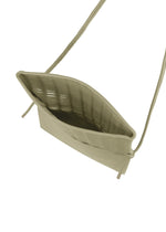 A top view of the open, empty MOKKO FLAP POUCH by GOOD GOODS ISSEY MIYAKE in light beige fabric with long drawstring straps shows its textured interior—ideal as a washable bag or casual shoulder bag.