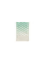 The MOKKO NET GRADATION by GOOD GOODS ISSEY MIYAKE is a small, green and white rectangular item with a cutout oval pattern on top and a solid white bottom, displayed on a plain white background.