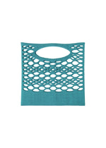 The MOKKO BASKET by GOOD GOODS ISSEY MIYAKE is a teal, rectangular basket bag featuring a mesh-style design with oval-shaped cutouts and an integrated handle, shown against a white background.