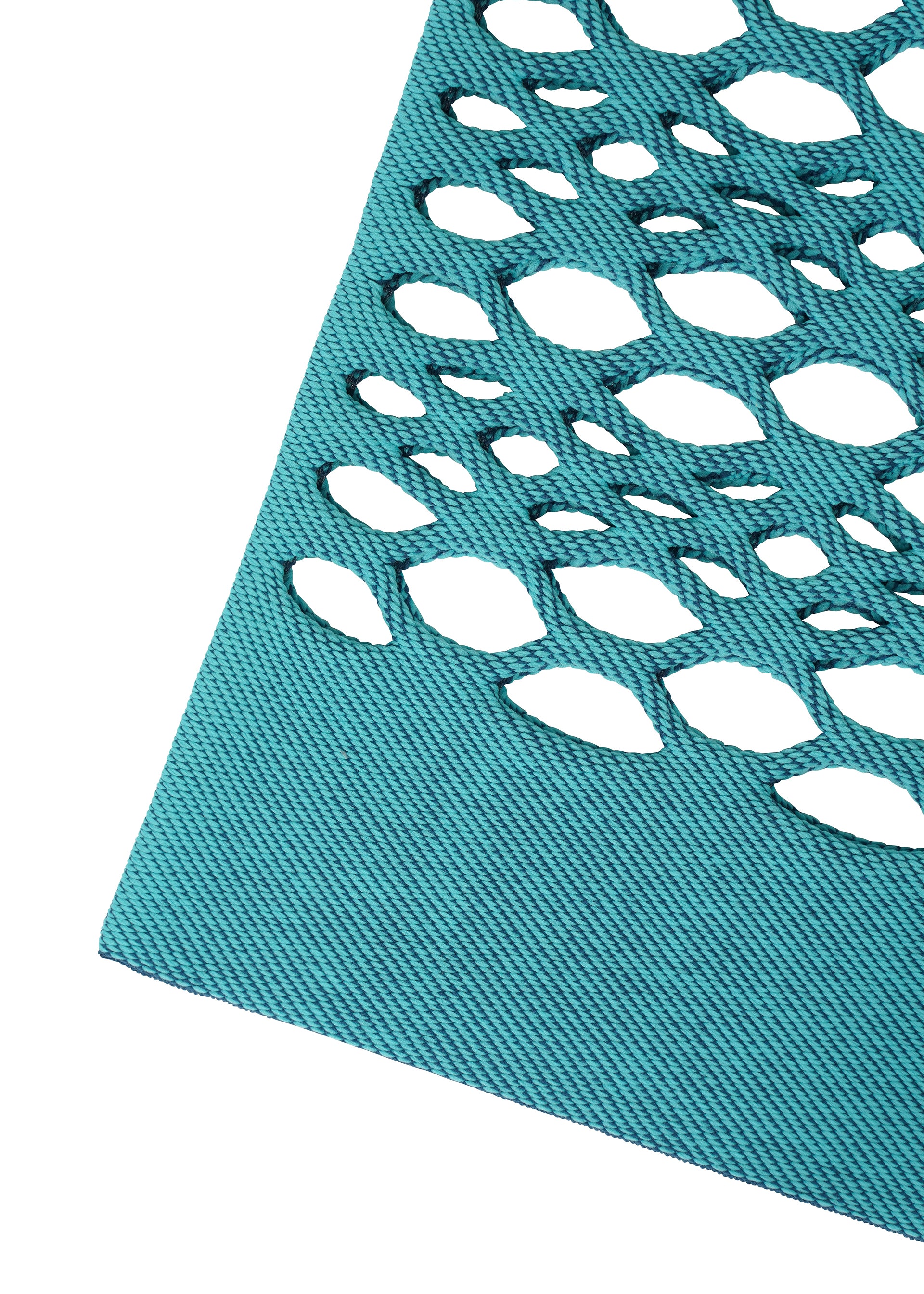 Zoomed view A close-up of teal fabric with an oval cutout pattern highlights the decorative, openwork design of the MOKKO BASKET by GOOD GOODS ISSEY MIYAKE—a stylish, washable knit tote.