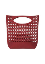 The MOKKO BASKET by GOOD GOODS ISSEY MIYAKE is a red, washable tote with oval perforations and an oval handle opening, shown against a white background. - DARK BORDEAUX×CRIMSON RED （no.82）