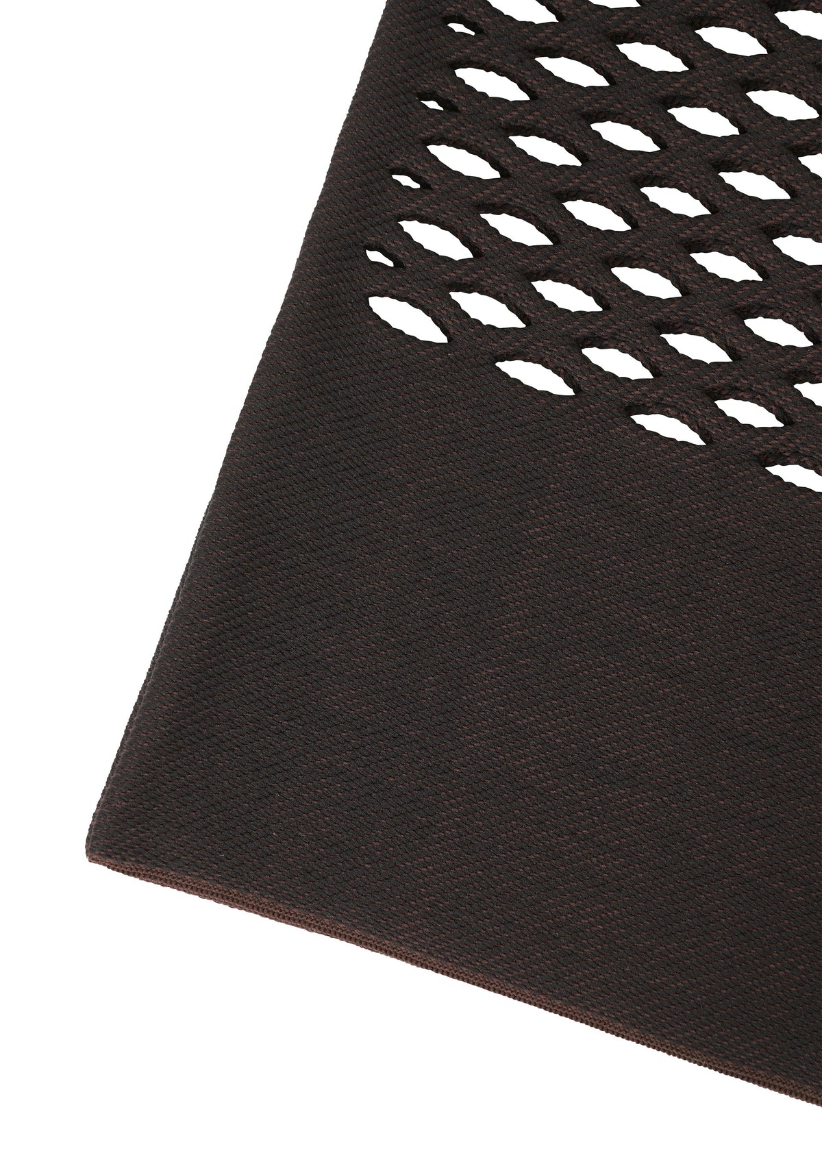 Close-up of the MOKKO BASKET by GOOD GOODS ISSEY MIYAKE, showing its dark brown textured material with diagonal oval cutouts, reminiscent of an intricately designed knit tote bag, set against a white background. view 6 of 9