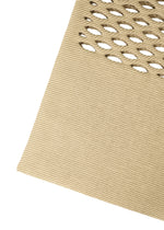 Close-up of the MOKKO BASKET by GOOD GOODS ISSEY MIYAKE: beige textured fabric with diagonal lines and diamond-shaped perforations, evoking the intricate weave seen in basket bags and knit drawstring bag designs.