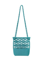 The MOKKO BASKET by GOOD GOODS ISSEY MIYAKE is a teal woven bag with large oval cutouts on top, solid fabric below, two long braided straps, and a washable finish for easy care.