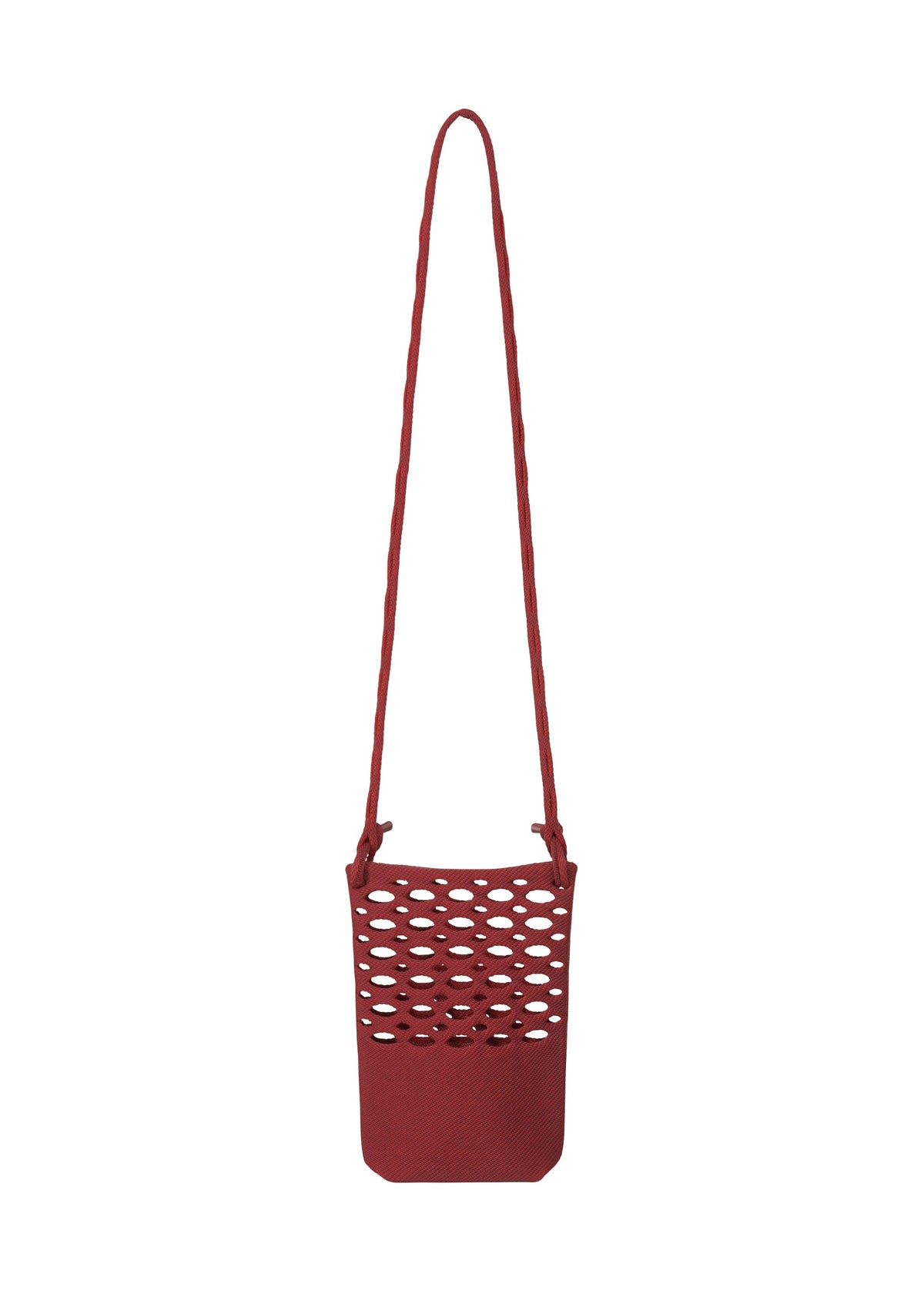 The MOKKO BASKET by GOOD GOODS ISSEY MIYAKE is a small red shoulder bag with a long strap and open honeycomb-style cutouts on the front, reminiscent of a chic knit pochette. view 3 of 8