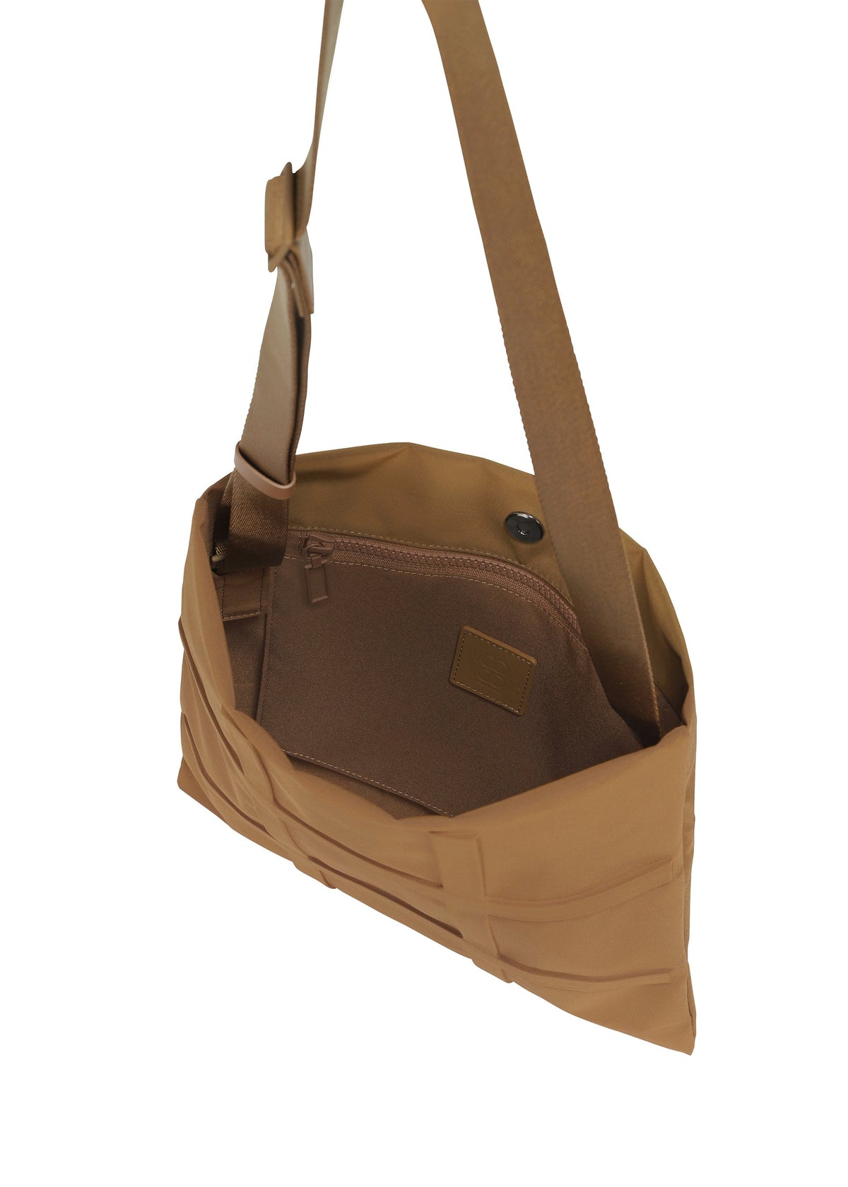 The GRID bag by GOOD GOODS ISSEY MIYAKE features a tan woven exterior, an adjustable strap, and opens to a brown fabric-lined interior with a zippered pocket. view 5 of 10