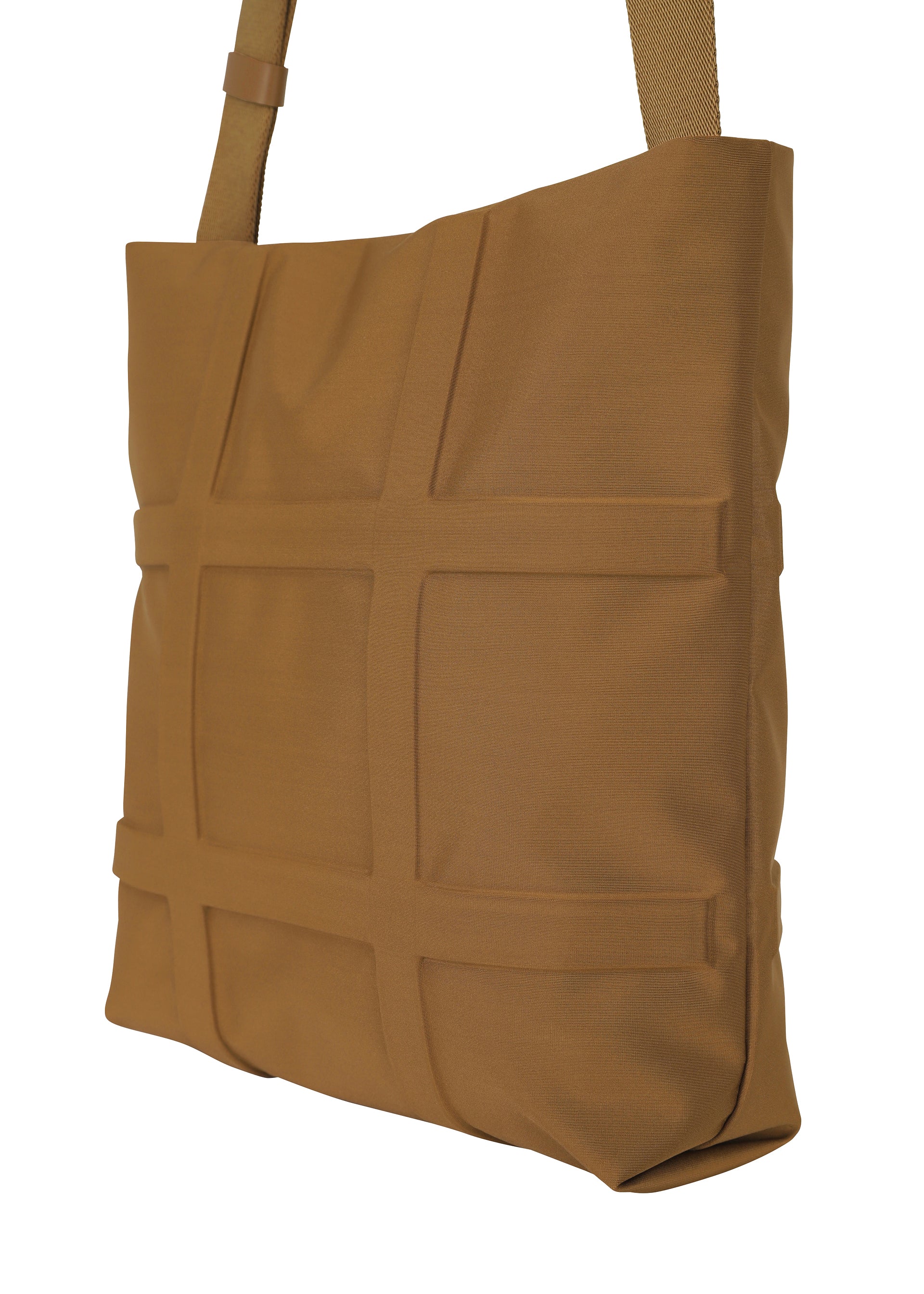 Zoomed view The GRID shoulder bag by GOOD GOODS ISSEY MIYAKE features a tan, rectangular design with a textured grid front and matching strap, crafted from sturdy fabric.