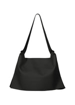 The ROLL by GOOD GOODS ISSEY MIYAKE is a large black shoulder bag with a wide strap and minimalist, unstructured design, featuring an elegant sheen and displayed on a white background. - BLACK （no.15）