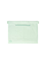 The ROLL by GOOD GOODS ISSEY MIYAKE is a large, flat white lightweight bag featuring a front horizontal zipper pocket and a subtle light green logo in the bottom left corner, shown against a plain white background.